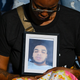 The girlfriend of Donovan Lewis holds a picture of him during a rally at the Columbus Division of Police Headquarters on September 2, 2022, in Columbus, Ohio. Lewis, a 20-year-old Black man, was shot and killed while in bed by Columbus Police as they were serving an arrest warrant on Aug. 30th.